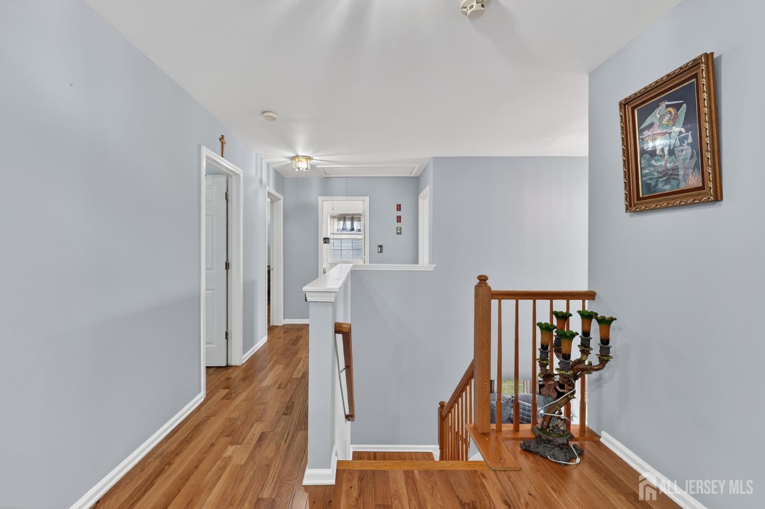 351 Wedgewood Road Morganville, NJ 07751 - Photo 60 of 74 a view of a hallway with wooden floor and stairs