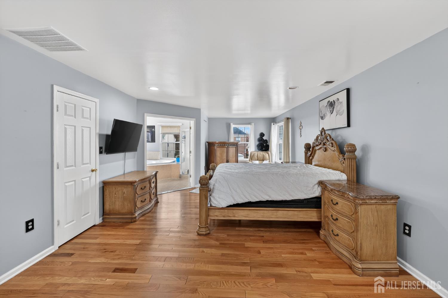 351 Wedgewood Road Morganville, NJ 07751 - Photo 62 of 74 a bedroom with furniture and flat screen tv