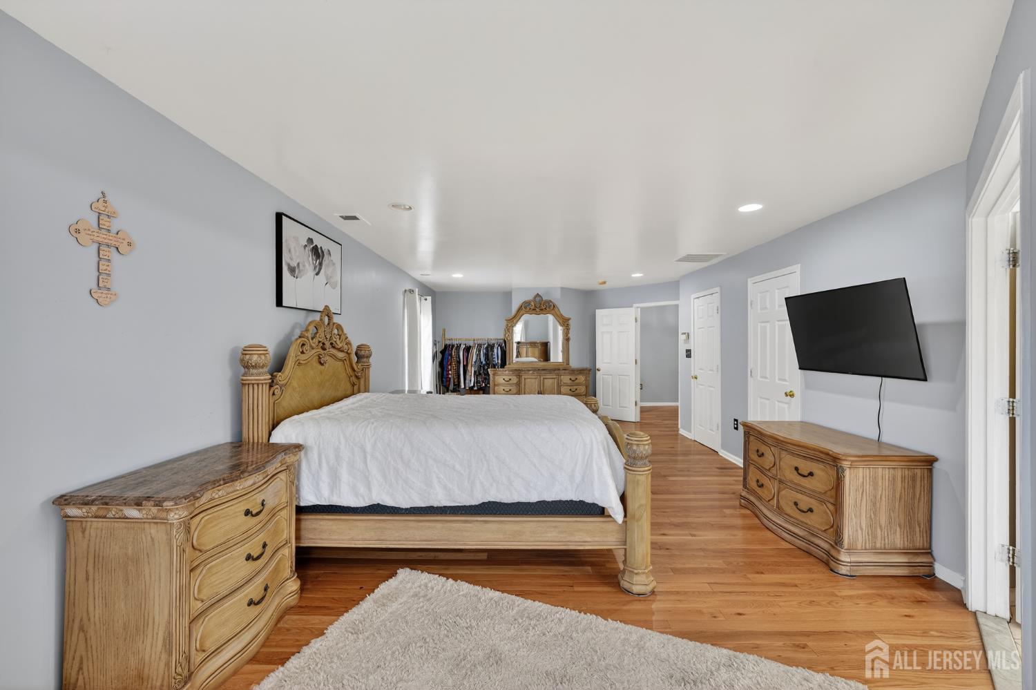351 Wedgewood Road Morganville, NJ 07751 - Photo 63 of 74 a spacious bedroom with a bed and a flat screen tv