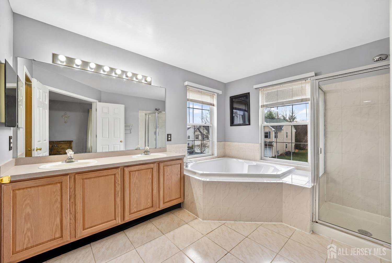 351 Wedgewood Road Morganville, NJ 07751 - Photo 66 of 74 a large bathroom with a large tub and sink