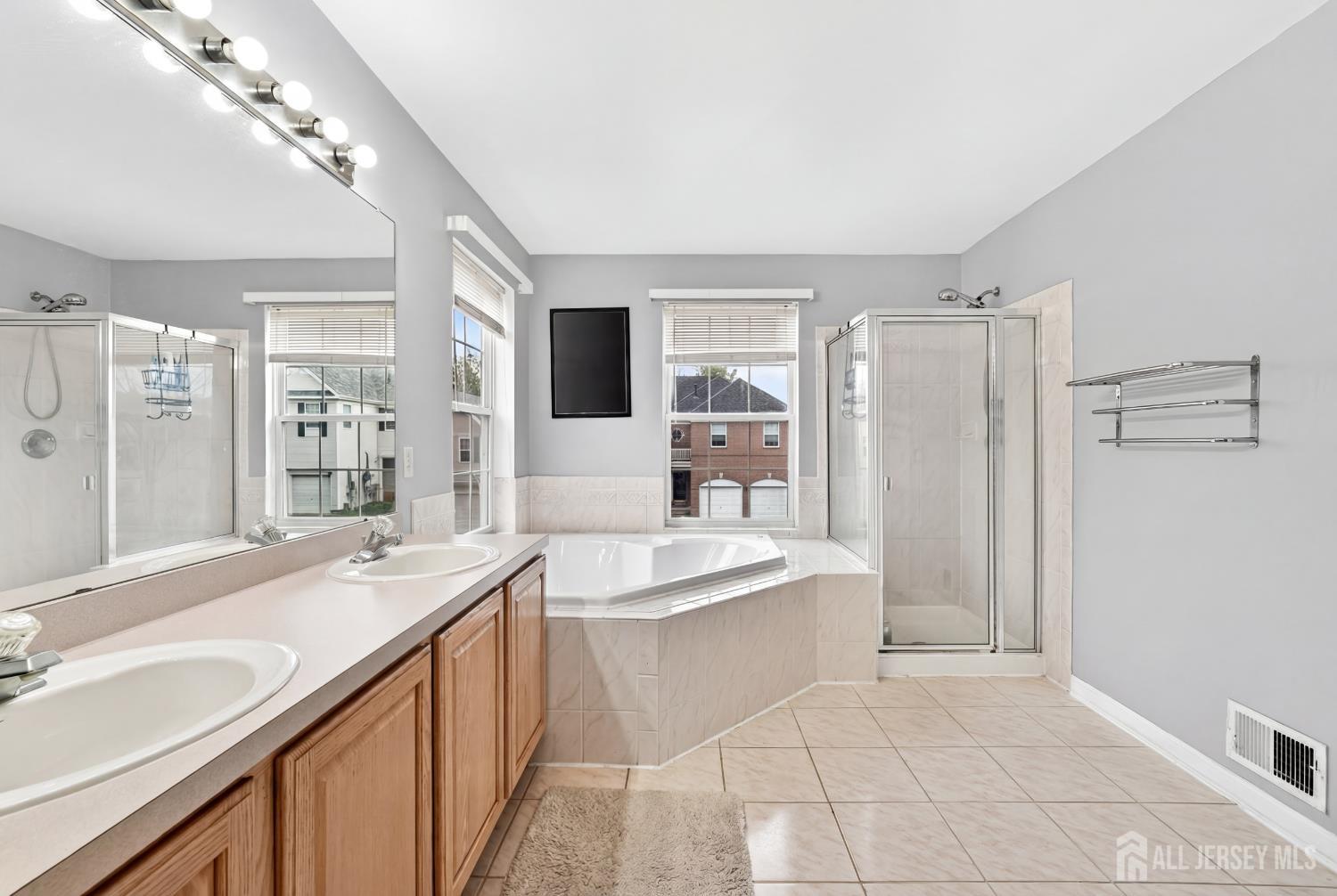 351 Wedgewood Road Morganville, NJ 07751 - Photo 67 of 74 a spacious bathroom with a double vanity sink mirror and shower