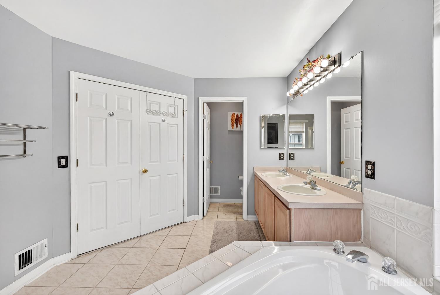 351 Wedgewood Road Morganville, NJ 07751 - Photo 68 of 74 a spacious bathroom with a tub sink and mirror