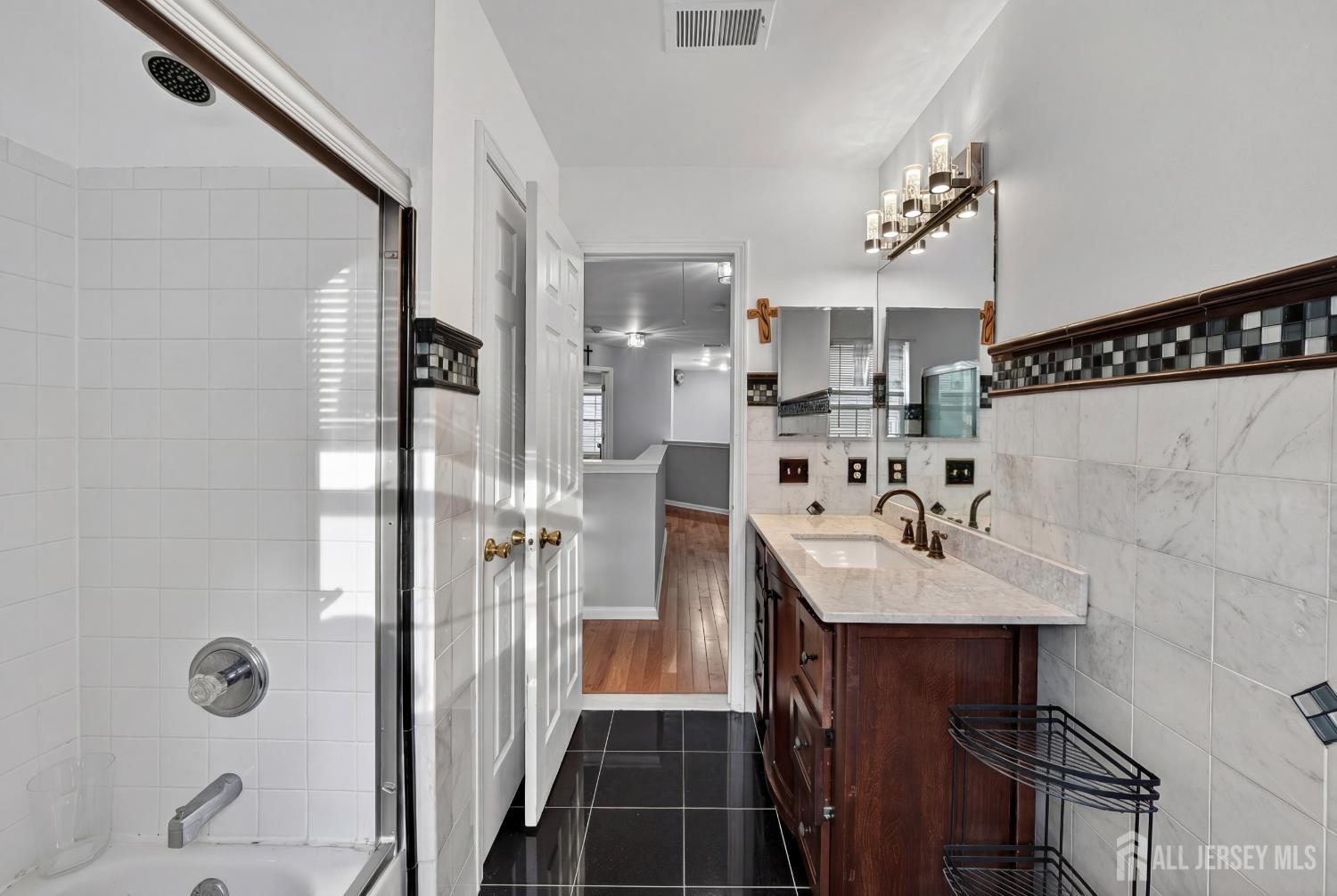351 Wedgewood Road Morganville, NJ 07751 - Photo 74 of 74 a bathroom with a sink and a mirror