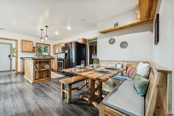 a view of a dining room with furniture and wooden floor