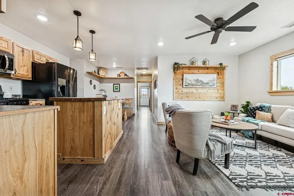 a living room with furniture and a wooden floor