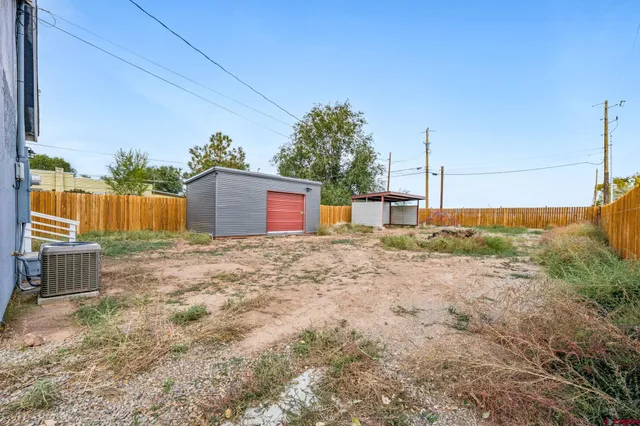 a backyard of a house with a yard and garage