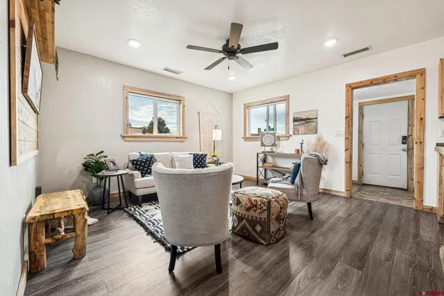 a living room with furniture and a wooden floor
