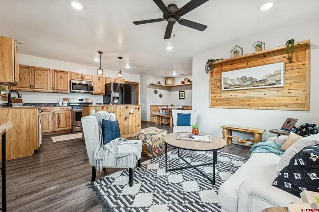 a living room with stainless steel appliances kitchen island granite countertop furniture and a kitchen view