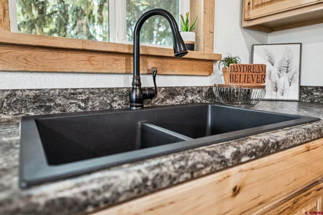 a view of a kitchen island with a sink and wooden floor