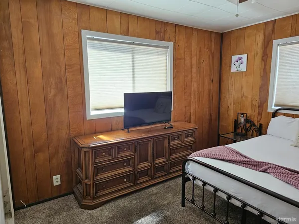 a bedroom with a bed and a dresser