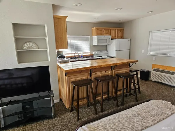 a kitchen with a stove a sink and a refrigerator