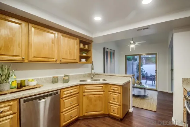 a kitchen with stainless steel appliances granite countertop a stove a microwave and view living room