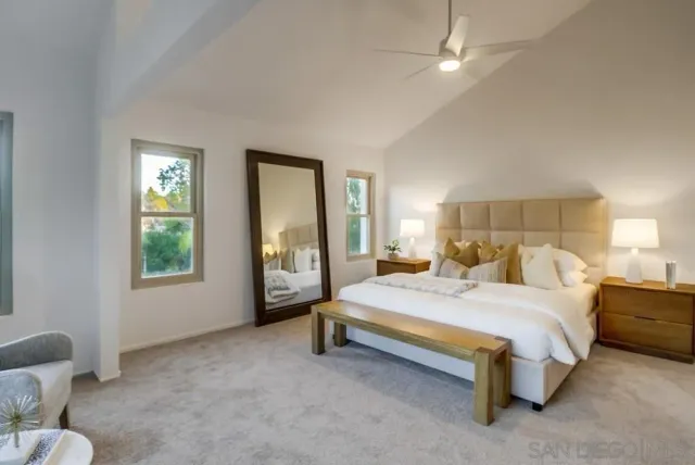 a bedroom with a bed and a lamp