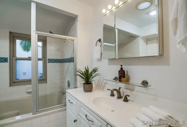 a bathroom with a shower and a sink