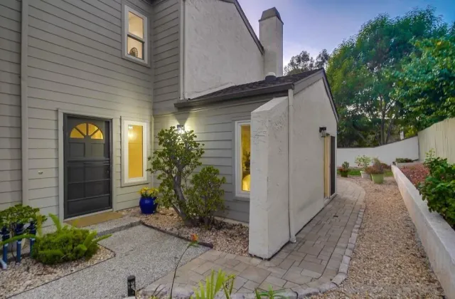 a backyard of a house with plants and trees