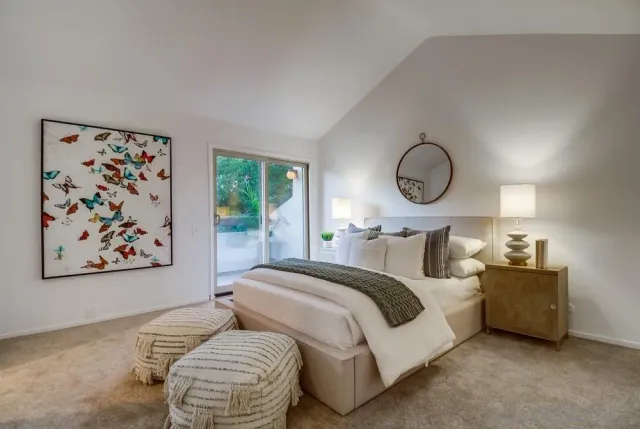a bedroom with bed and a chandelier