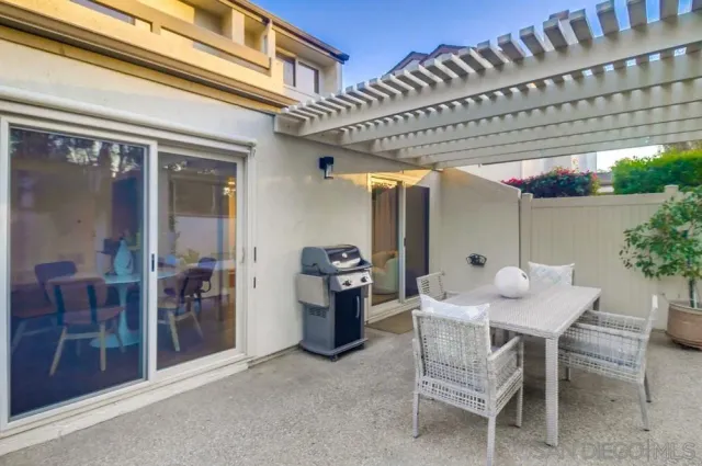 a view of a yard with wooden fence