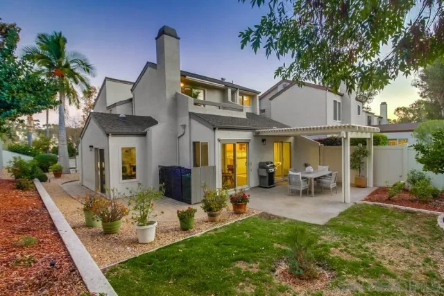 a view of a house with backyard porch and sitting area