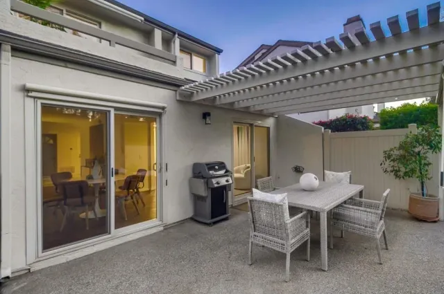 a view of a patio with table and chairs