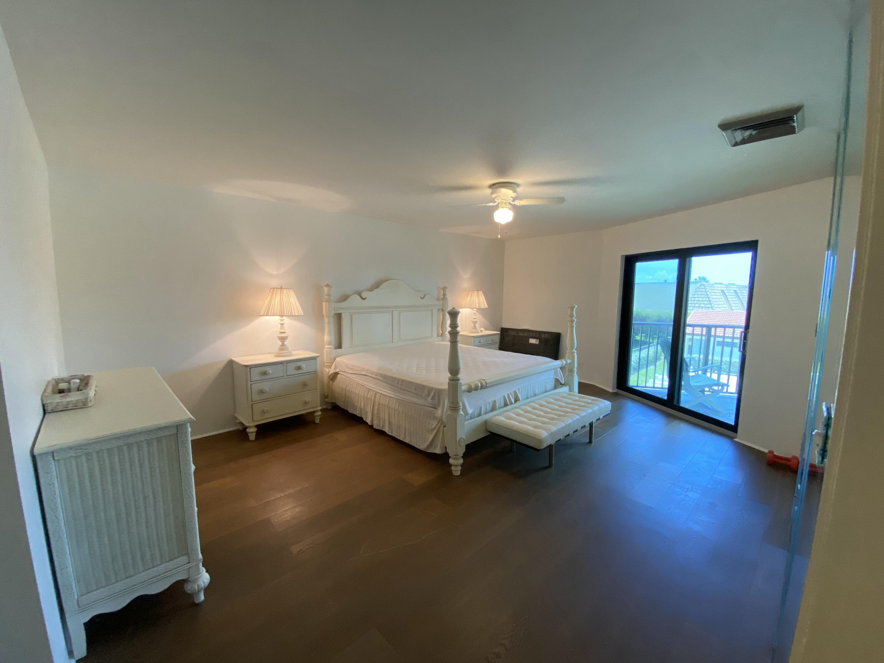 5801 North Ocean Boulevard, Unit 208 Ocean Ridge, FL 33435 - Photo 6 of 7 a spacious bedroom with a bed and wooden floor