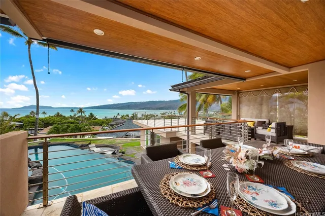 a dining room with furniture and a floor to ceiling window