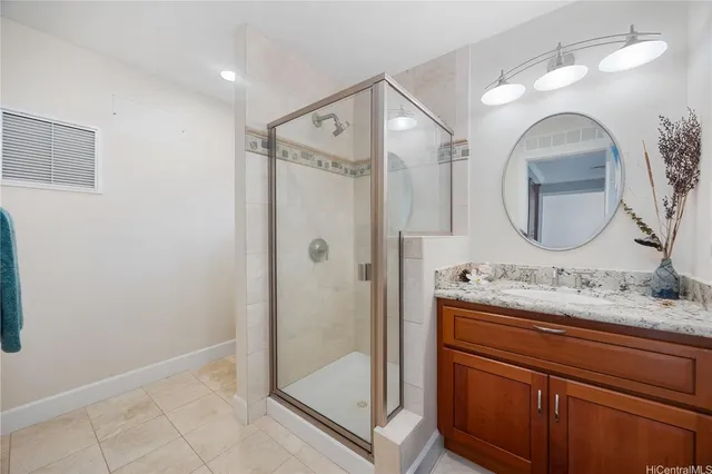 a bathroom with a sink a mirror a vanity and shower