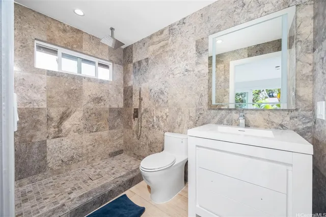 a bathroom with a sink a toilet and a mirror