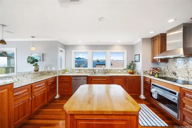a large kitchen with stainless steel appliances granite countertop a sink and cabinets