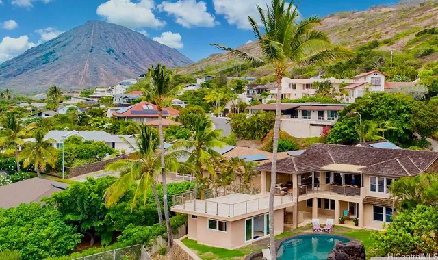 a aerial view of multi story residential apartment building with a yard