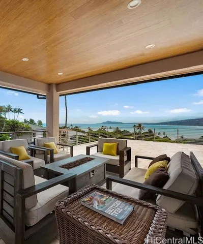 a living room with lots of furniture and a floor to ceiling window