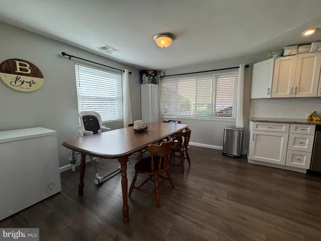 a view of a dining room with furniture and window
