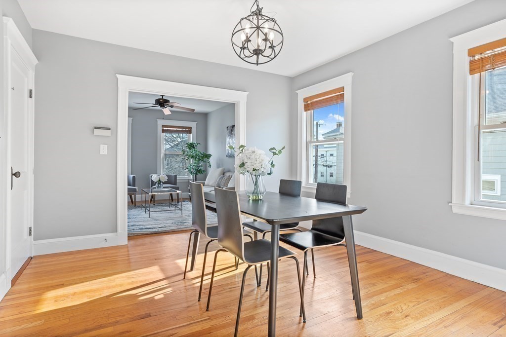132 Rawson Road, Unit 132 Arlington, MA 02474 - Photo 11 of 26 a view of a dining room with furniture window and wooden floor