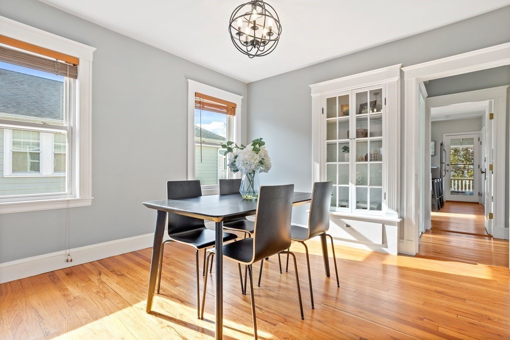 132 Rawson Road, Unit 132 Arlington, MA 02474 - Photo 12 of 26 a view of a dining room with furniture wooden floor and a chandelier