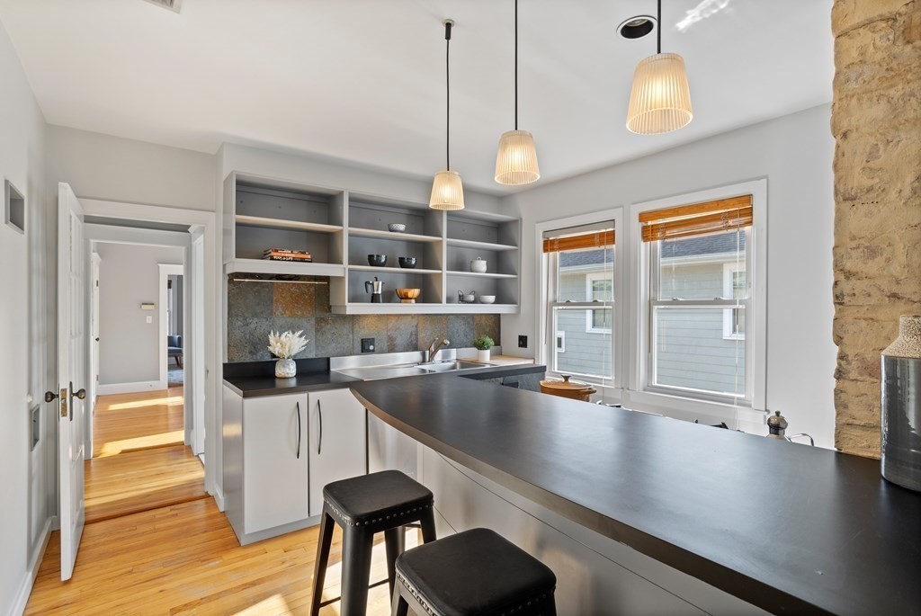 132 Rawson Road, Unit 132 Arlington, MA 02474 - Photo 16 of 26 a kitchen with granite countertop a sink appliances and cabinets