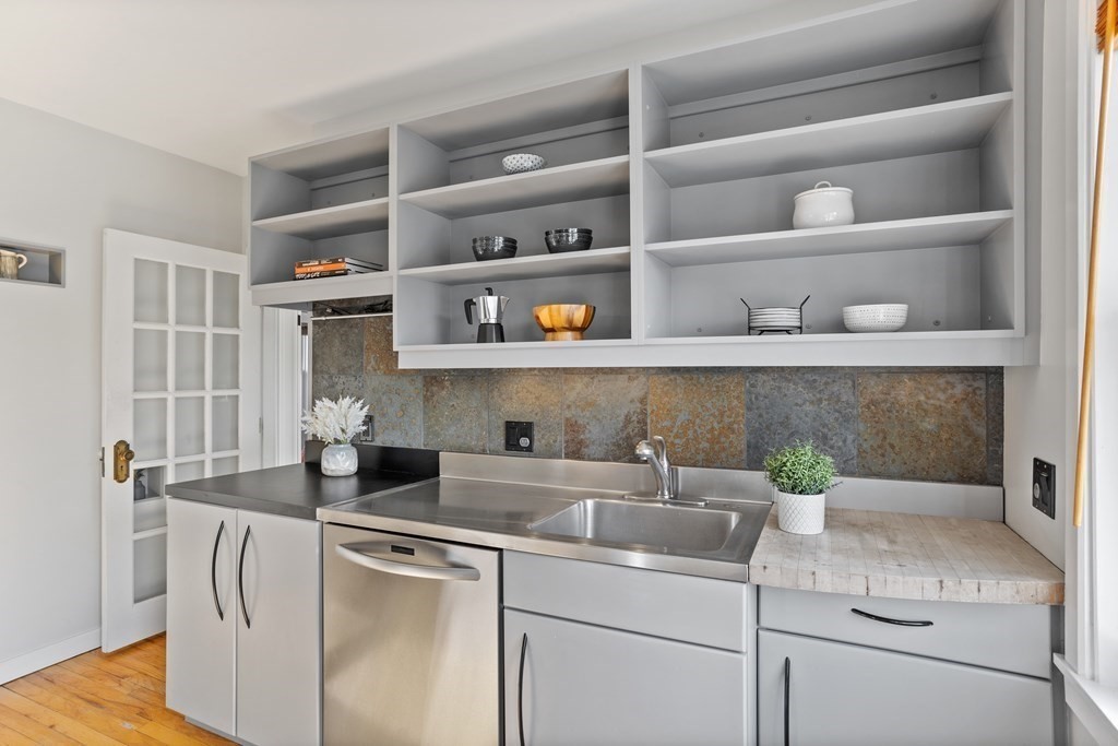 132 Rawson Road, Unit 132 Arlington, MA 02474 - Photo 17 of 26 a kitchen with a sink and cabinets