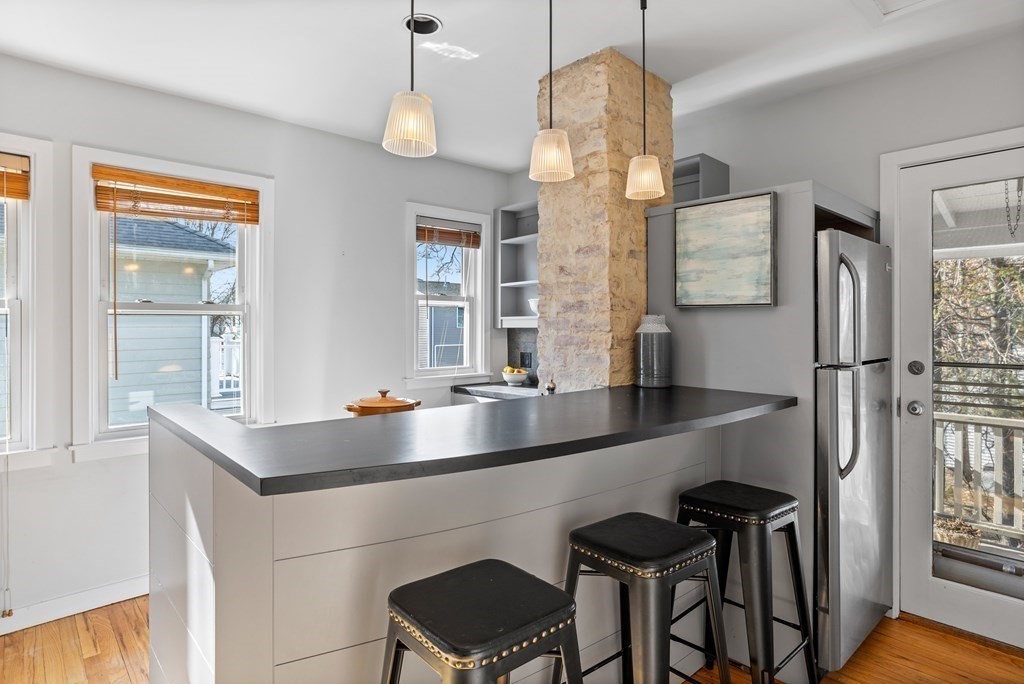 132 Rawson Road, Unit 132 Arlington, MA 02474 - Photo 18 of 26 a kitchen with center island and two windows