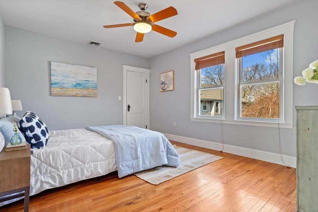132 Rawson Road, Unit 132 Arlington, MA 02474 - Photo 20 of 26 a bedroom with a bed and a window
