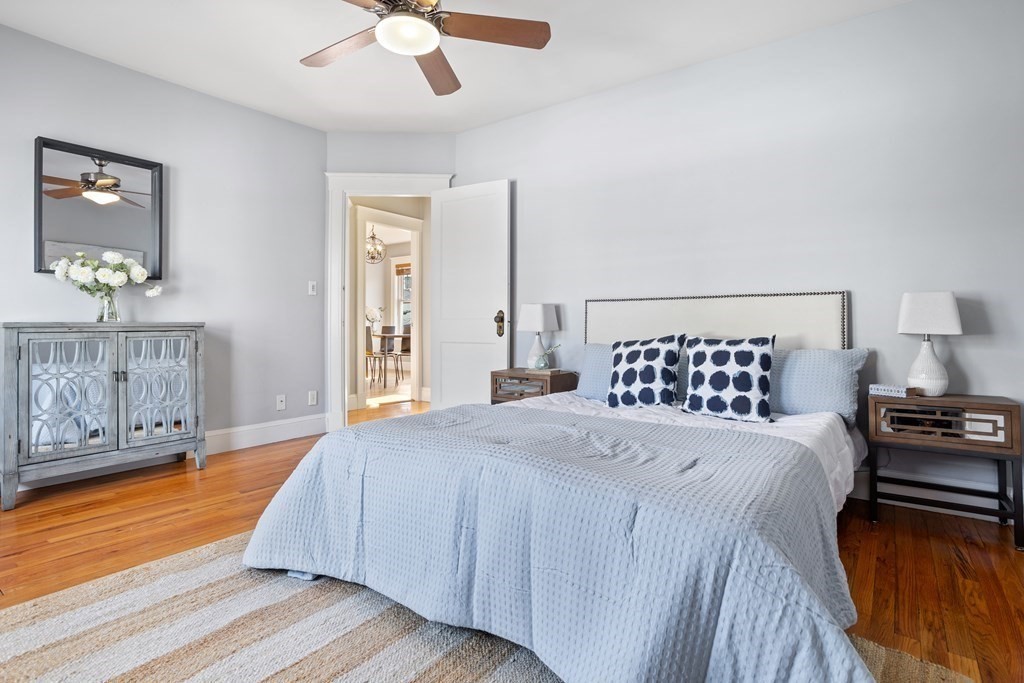 132 Rawson Road, Unit 132 Arlington, MA 02474 - Photo 21 of 26 a bedroom with a bed and a chandelier