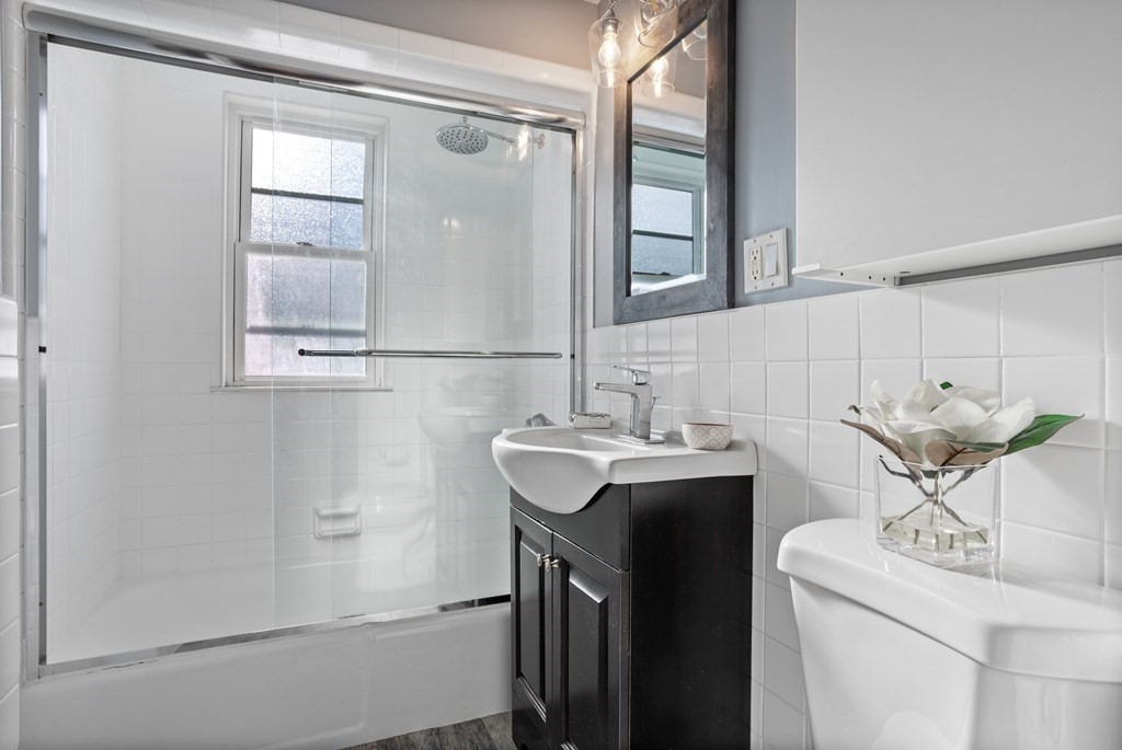 132 Rawson Road, Unit 132 Arlington, MA 02474 - Photo 22 of 26 a bathroom with a sink and a mirror