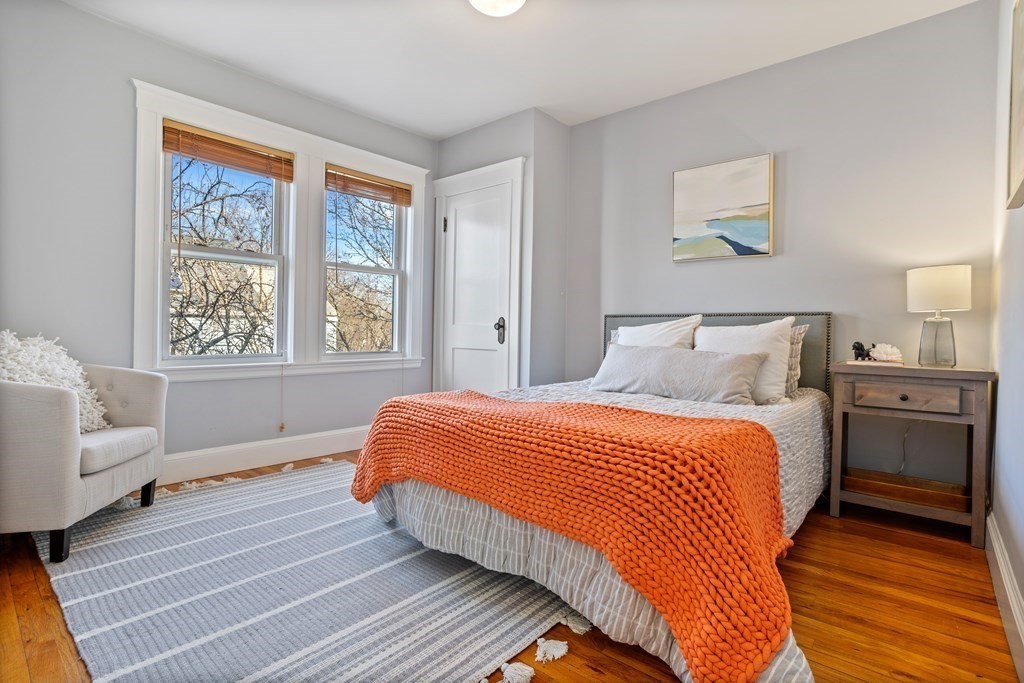 132 Rawson Road, Unit 132 Arlington, MA 02474 - Photo 23 of 26 a bedroom with a bed and a couch