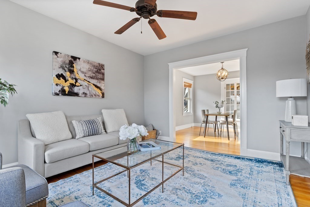 132 Rawson Road, Unit 132 Arlington, MA 02474 - Photo 3 of 26 a living room with furniture and a rug