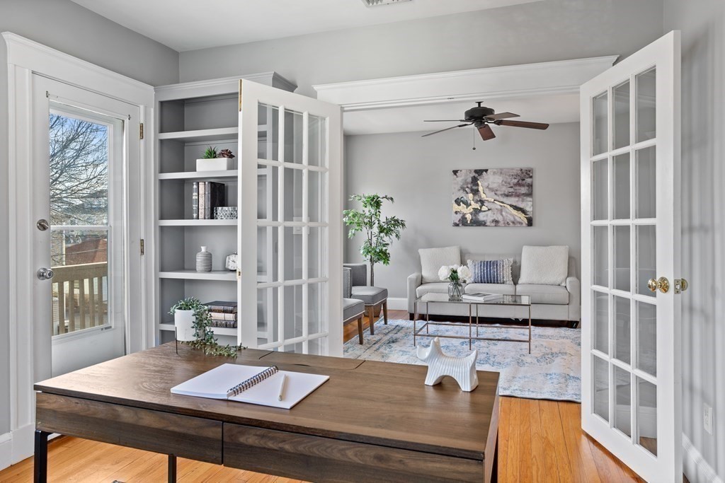 132 Rawson Road, Unit 132 Arlington, MA 02474 - Photo 7 of 26 a living room with fireplace furniture and a window