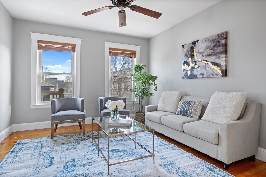 132 Rawson Road, Unit 132 Arlington, MA 02474 - Photo 8 of 26 a living room with furniture and a rug