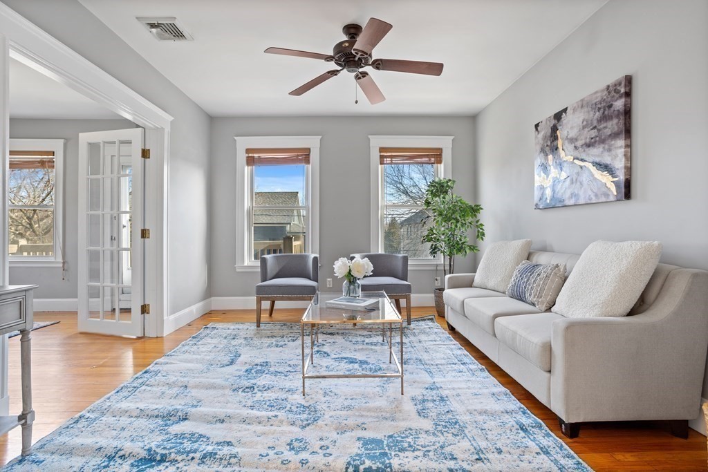 132 Rawson Road, Unit 132 Arlington, MA 02474 - Photo 9 of 26 a living room with furniture and wooden floor
