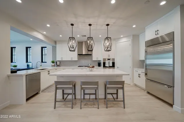 a large kitchen with a table and chairs in it