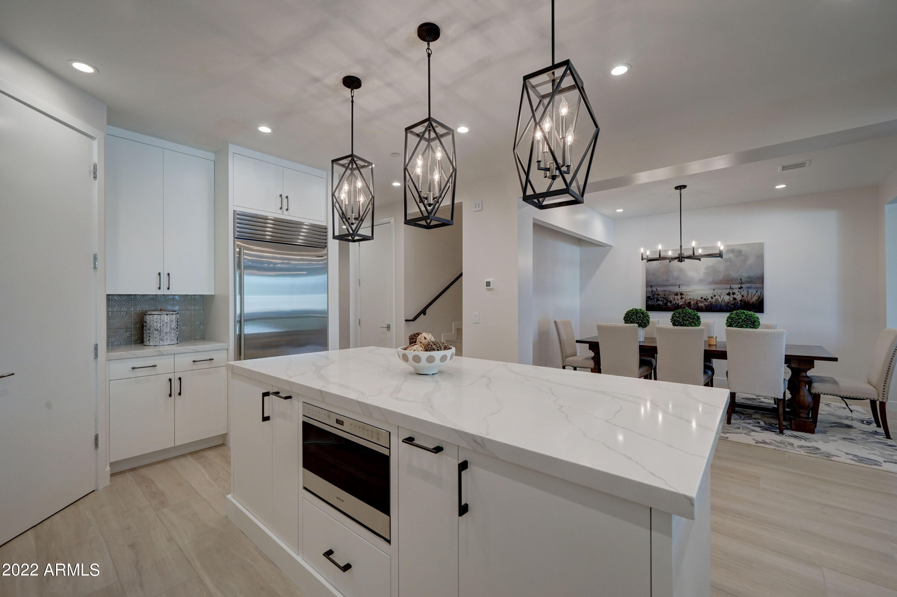 6500 East Camelback Road, Unit 1006 Scottsdale, AZ 85251 - Photo 11 of 38 a kitchen with stainless steel appliances granite countertop a sink a stove top oven a clock and cabinets