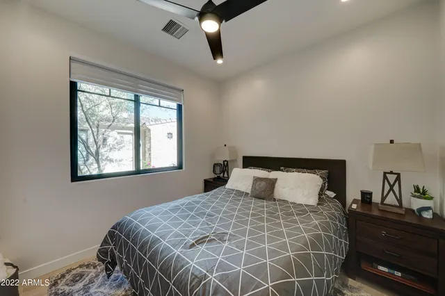 a bedroom with a large bed and a window