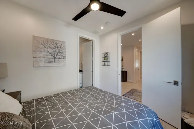 a bedroom with a bed and a painting on the wall