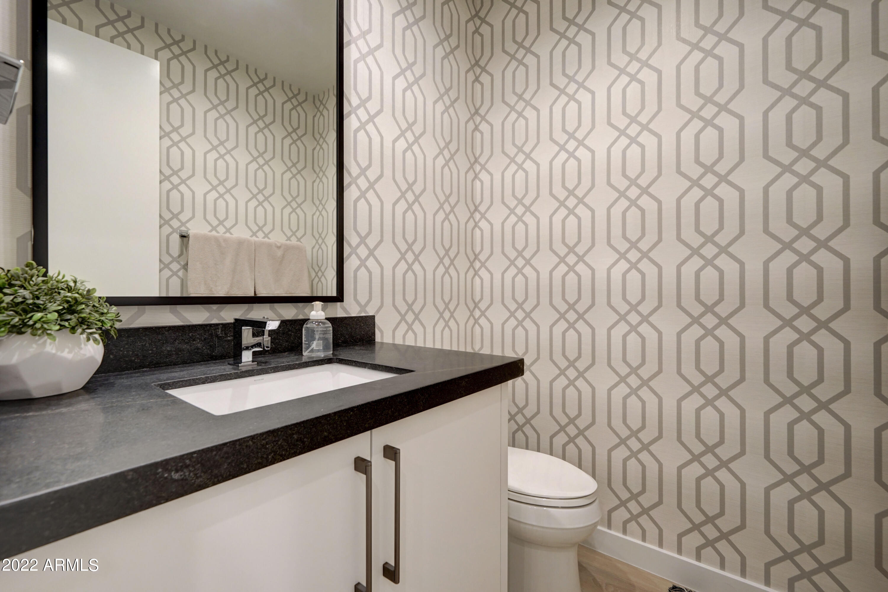 6500 East Camelback Road, Unit 1006 Scottsdale, AZ 85251 - Photo 17 of 38 a bathroom with a granite countertop sink and a toilet
