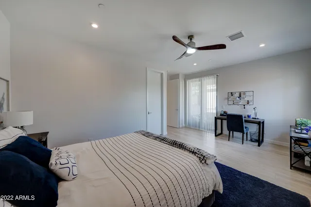 a bedroom with a bed a desk and chair